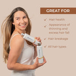 Woman holding Neutriderm Hair Enhancer Shampoo with text highlighting product benefits on a beige background