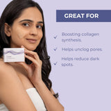 Image of a model smiling and holding Neutriderm Exfoliator Set Vitamin C Scrub & Copper Activator Serum with the text describing the benefits, boosting collagen synthesis, helps unclog pores & reduce dark spots.