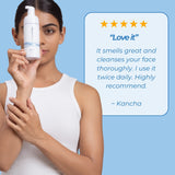 Woman holding Neutriderm Foaming Cleanser with a customer review saying, 'Love it - It smells great and cleanses your face thoroughly. I use it twice daily. Highly recommend.' by Kancha. 