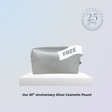 Silver cosmetic pouch with 'FREE' label on a light blue background, celebrating the 25th anniversary.